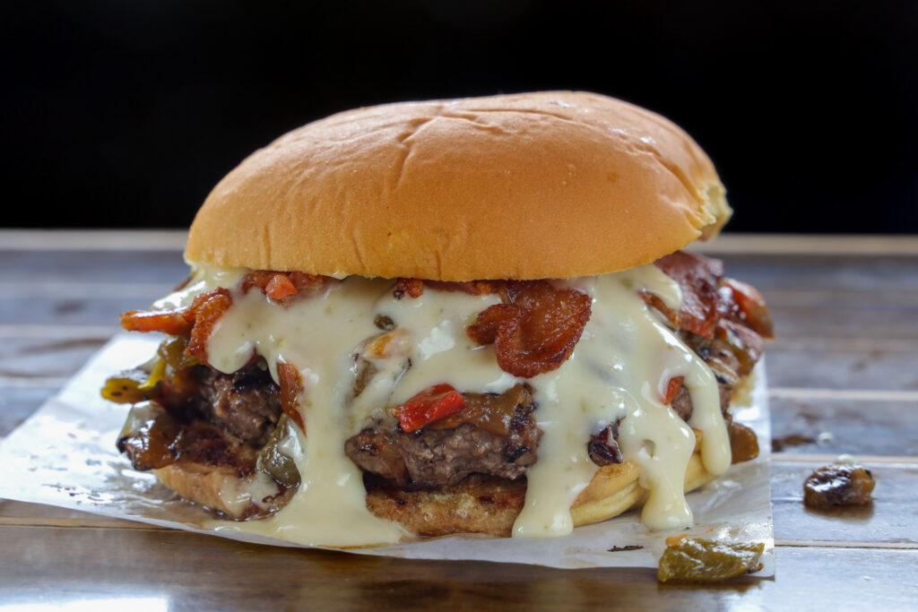 Double smash burger with queso and crispy bacon,
